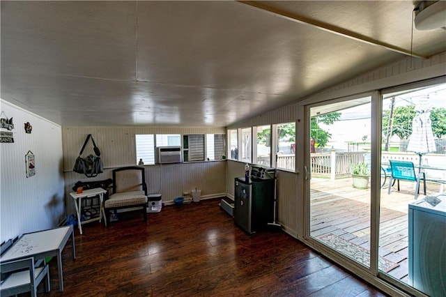 interior space with cooling unit, dark hardwood / wood-style flooring, vaulted ceiling, and baseboard heating