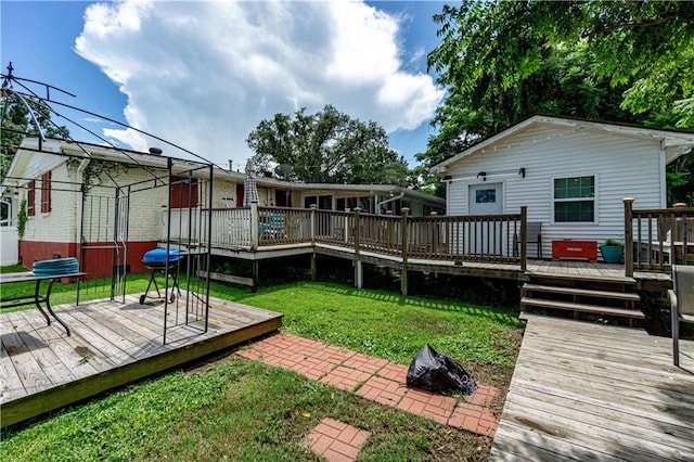 back of house featuring a yard and a wooden deck