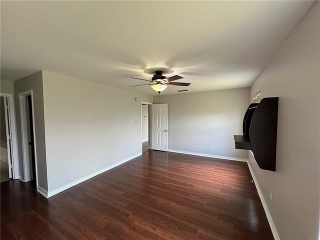 unfurnished living room featuring visible vents, baseboards, ceiling fan, and dark wood-style flooring