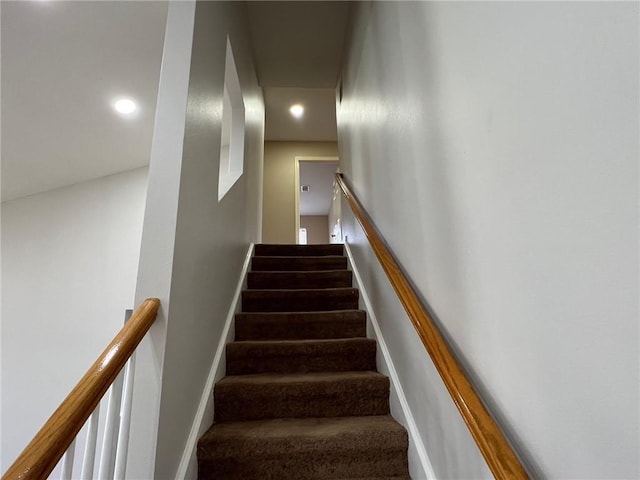 staircase with recessed lighting, baseboards, and carpet