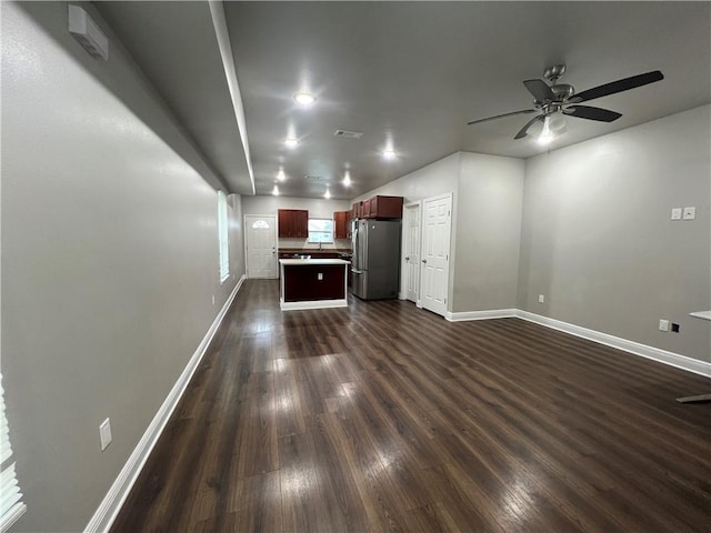 unfurnished living room with dark wood-type flooring and ceiling fan