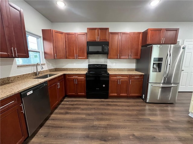 kitchen with sink, light stone countertops, dark hardwood / wood-style flooring, and black appliances