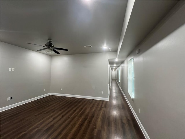 spare room featuring dark hardwood / wood-style floors and ceiling fan