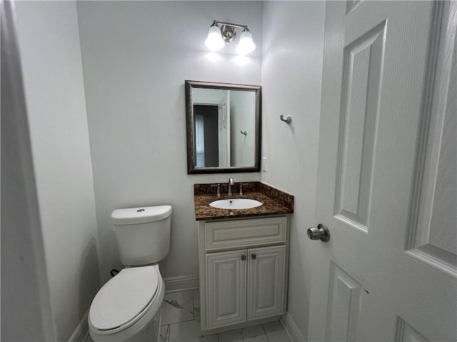 bathroom featuring vanity, tile patterned flooring, and toilet