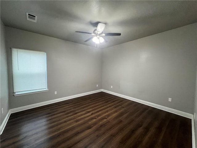 empty room with hardwood / wood-style floors and ceiling fan