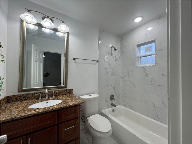 full bathroom featuring vanity, tiled shower / bath, tile patterned floors, and toilet