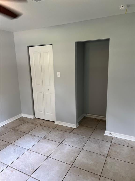 interior space featuring light tile patterned floors, ceiling fan, and plenty of natural light