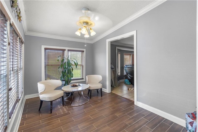 sitting room featuring crown molding and a textured ceiling