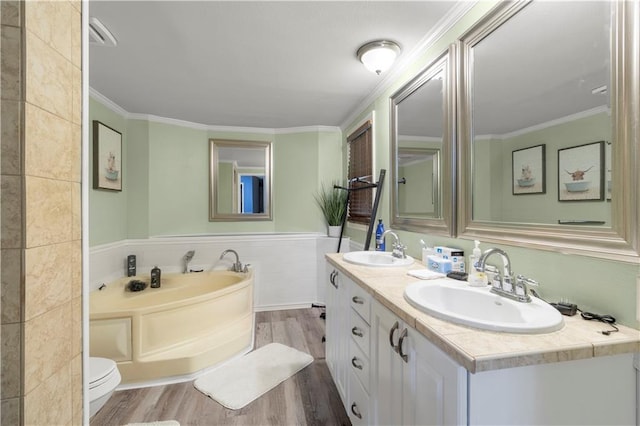 bathroom featuring toilet, crown molding, tile walls, vanity, and hardwood / wood-style flooring