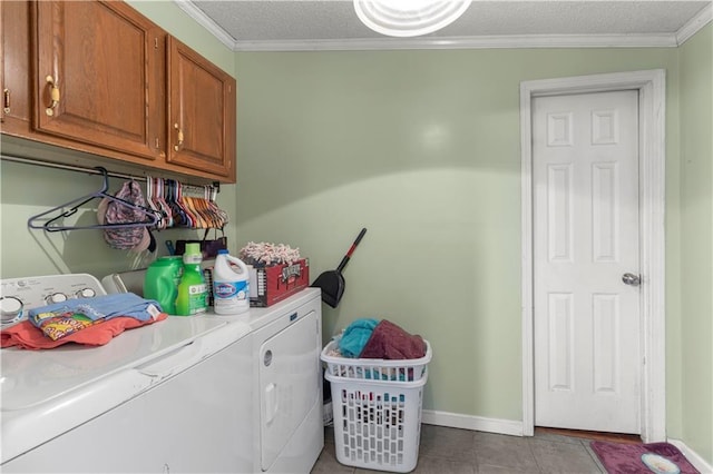 laundry room featuring cabinets, washing machine and dryer, ornamental molding, and a textured ceiling