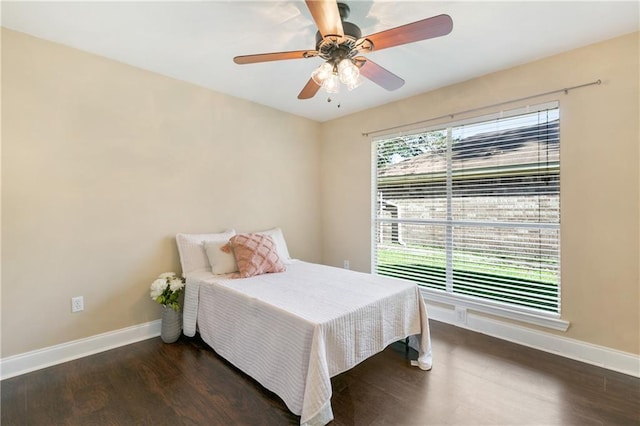 bedroom featuring ceiling fan and dark wood-type flooring