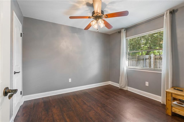 spare room featuring ceiling fan and dark wood-type flooring