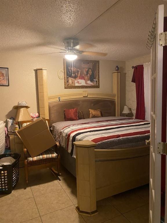 tiled bedroom featuring a textured ceiling and ceiling fan