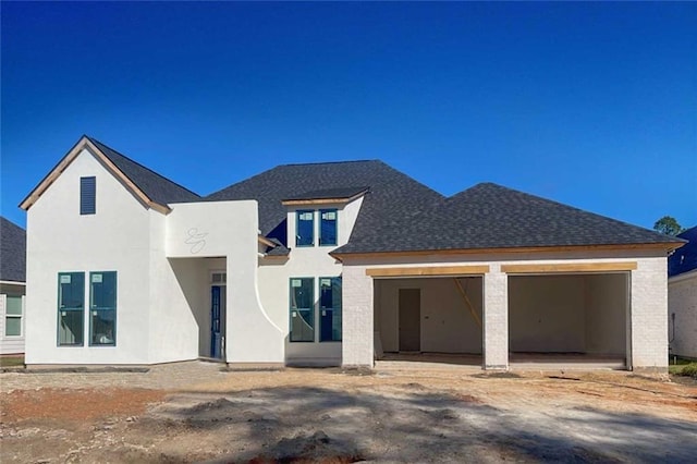 back of property featuring a garage