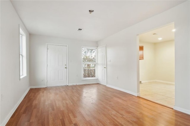 unfurnished room with hardwood / wood-style flooring