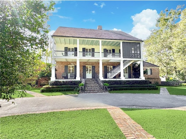 view of front of house with a porch and a front lawn