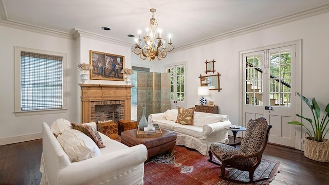 living room with a notable chandelier, dark hardwood / wood-style floors, ornamental molding, and a fireplace