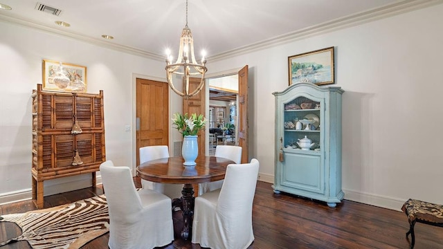 dining room with dark hardwood / wood-style flooring, ornamental molding, and a notable chandelier