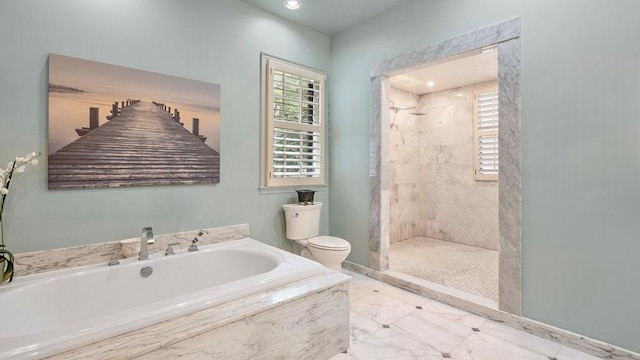 bathroom featuring separate shower and tub and toilet