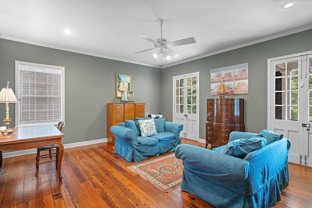 living room with ceiling fan, wood-type flooring, and ornamental molding