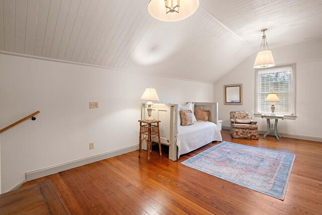 bedroom with hardwood / wood-style floors, wood ceiling, and vaulted ceiling