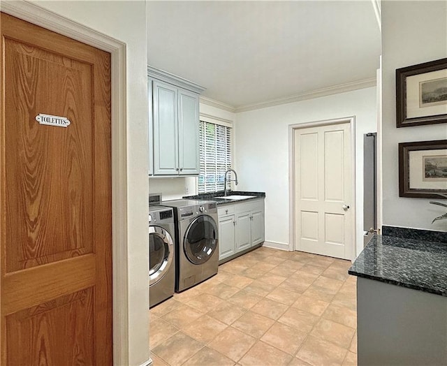 washroom featuring cabinets, independent washer and dryer, ornamental molding, and sink