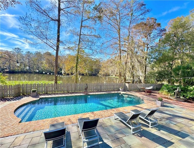 view of pool with a water view and a patio area