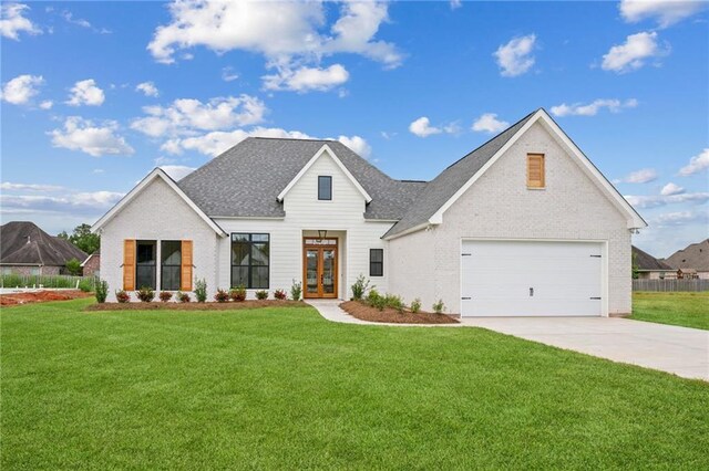 modern farmhouse featuring a garage and a front yard