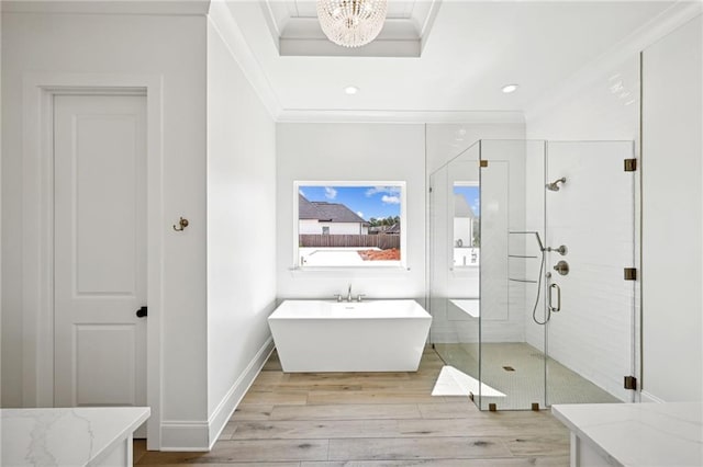 bathroom featuring ornamental molding, separate shower and tub, and wood-type flooring