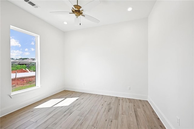 spare room with ceiling fan and light wood-type flooring