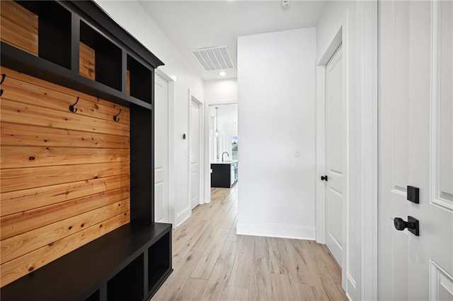 mudroom with light hardwood / wood-style floors