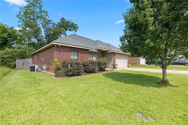 ranch-style home with a garage, a front lawn, and central AC