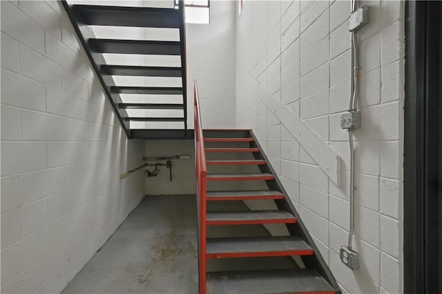 stairway featuring concrete flooring