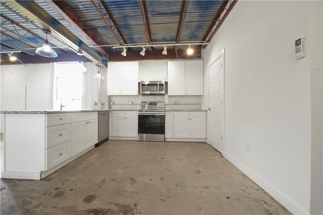 kitchen featuring appliances with stainless steel finishes, white cabinetry, and decorative light fixtures