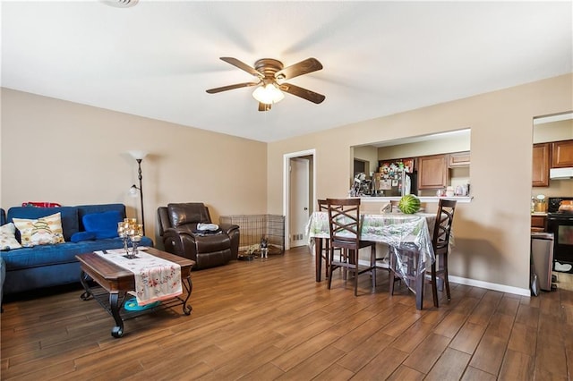 living room featuring dark hardwood / wood-style floors and ceiling fan