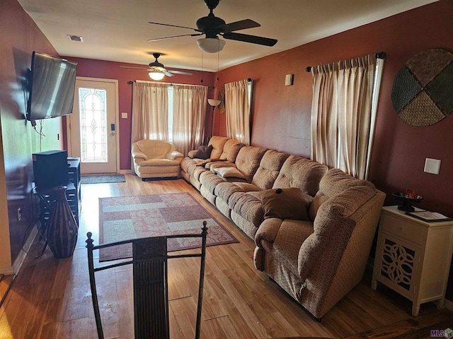 living room with ceiling fan and light wood-type flooring