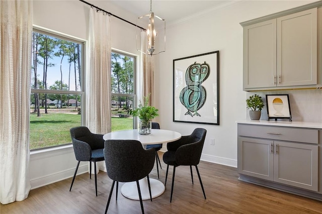 dining room featuring a chandelier, ornamental molding, and hardwood / wood-style flooring