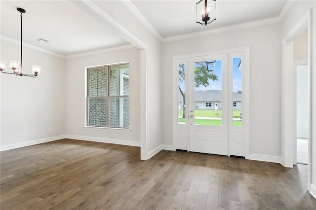 doorway featuring ornamental molding, a chandelier, and hardwood / wood-style floors