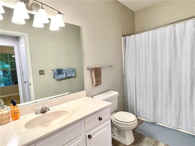 bathroom featuring vanity, hardwood / wood-style flooring, and toilet