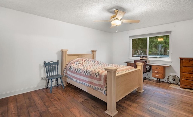 bedroom with ceiling fan, a textured ceiling, and dark hardwood / wood-style flooring