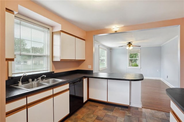 kitchen with white cabinets, sink, kitchen peninsula, dark tile patterned flooring, and ceiling fan