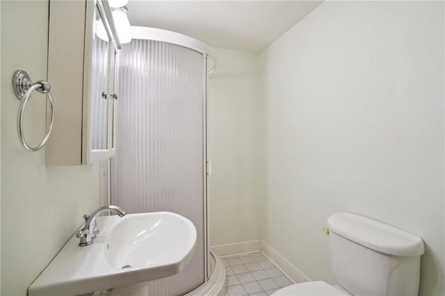 bathroom with tile patterned flooring, toilet, and sink