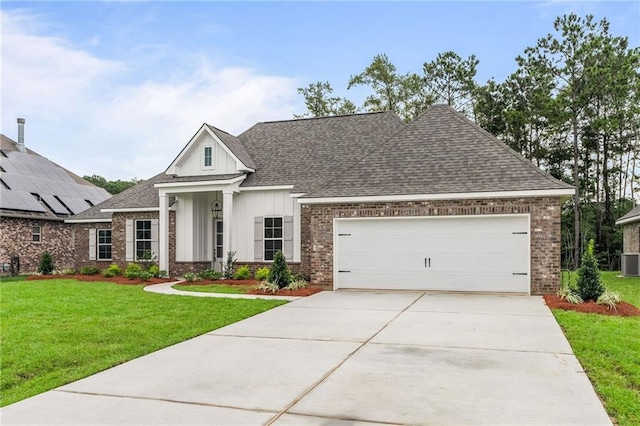 view of front of house featuring solar panels, a garage, a front lawn, and cooling unit