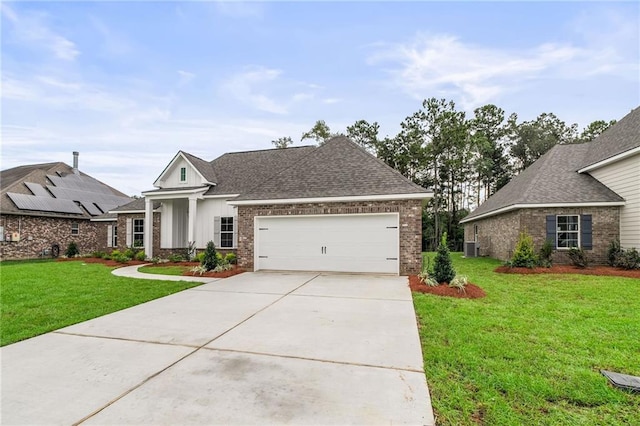 view of front of home featuring a garage, solar panels, and a front yard