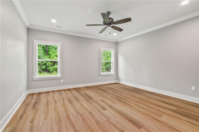 spare room with light wood-type flooring, ceiling fan, and ornamental molding