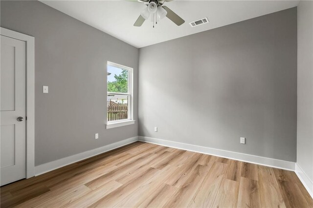 empty room featuring ceiling fan and light hardwood / wood-style flooring