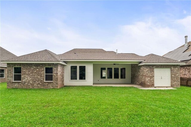 back of property featuring ceiling fan, a lawn, and a patio area