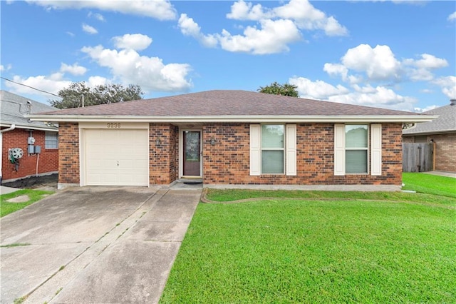 single story home featuring a garage and a front yard