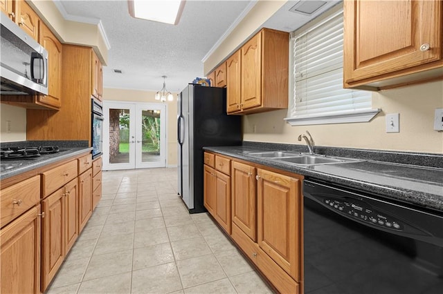 kitchen with appliances with stainless steel finishes, a textured ceiling, ornamental molding, and light tile patterned floors