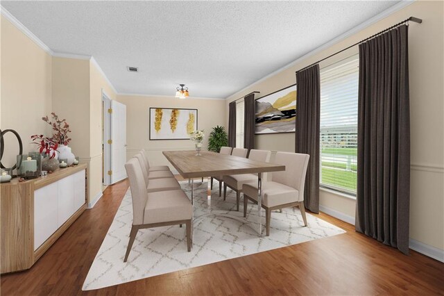 dining area with crown molding, a textured ceiling, and light hardwood / wood-style floors